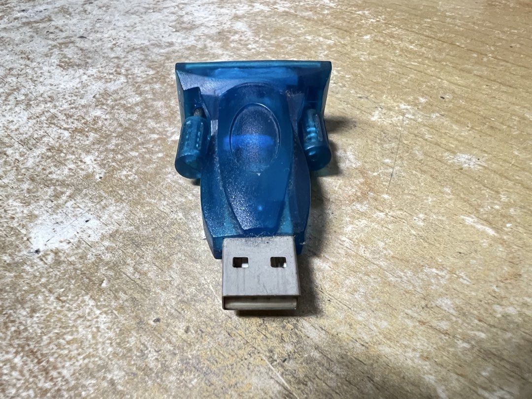 Mixed Items (Category: Cables & Adaptors) located in Singapore. Submitted by amk2025 (Listing ID 1451279339, Image 3). Description: - DVI to HDMI adapter - White adapter box with DVI, HDMI, and VGA ports - Includes short cable with micro USB connector for power - Blue USB to Serial adapter - Colors: Black, White, Blue - Ideal for connecting different types of displays.