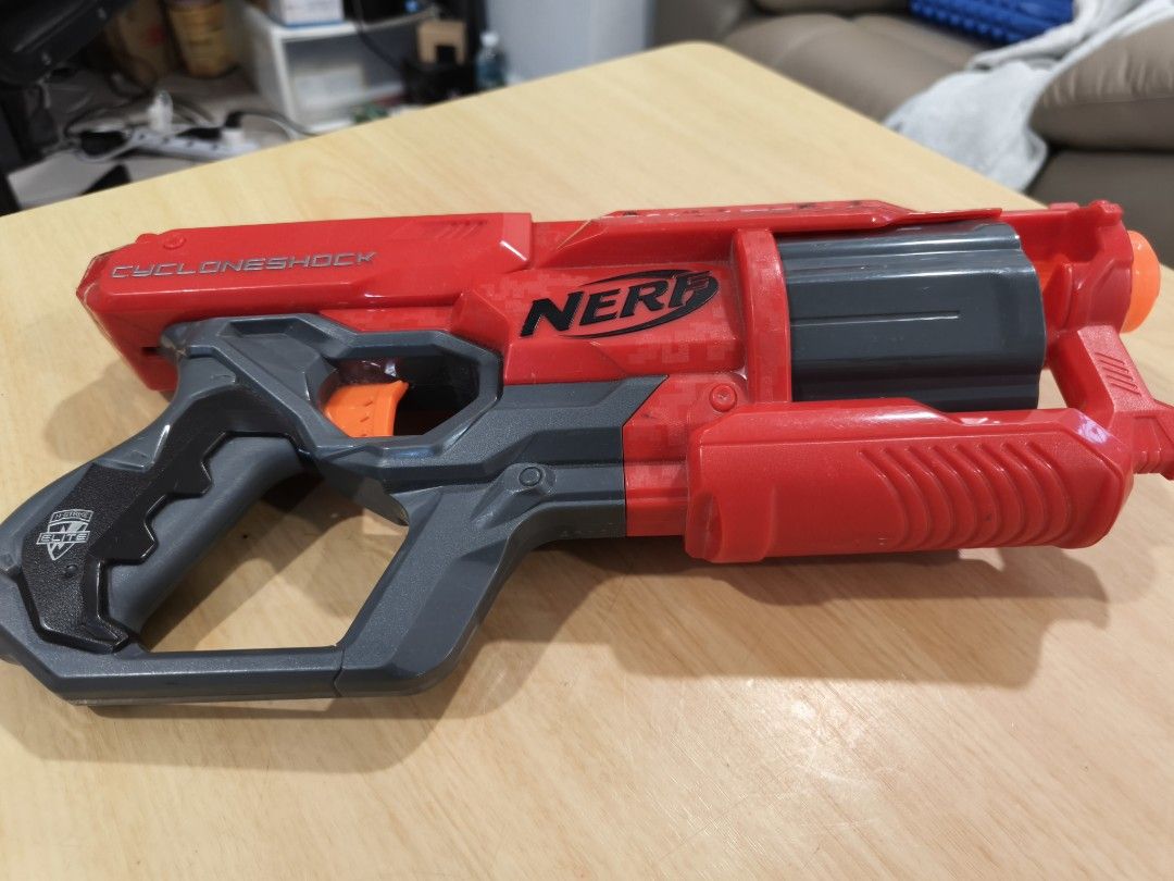 Nerf N-Strike Mega CycloneShock Blaster (Category: Toys & Games) located in Puchong. Submitted by gttrading (Listing ID 1451247857, Image 1). Description: - Red and grey Nerf Mega CycloneShock blaster - Fires Mega Whistler darts - Features a rotating barrel - Perfect for outdoor fun - Shows minor scuffs from normal play, but still works perfectly!.