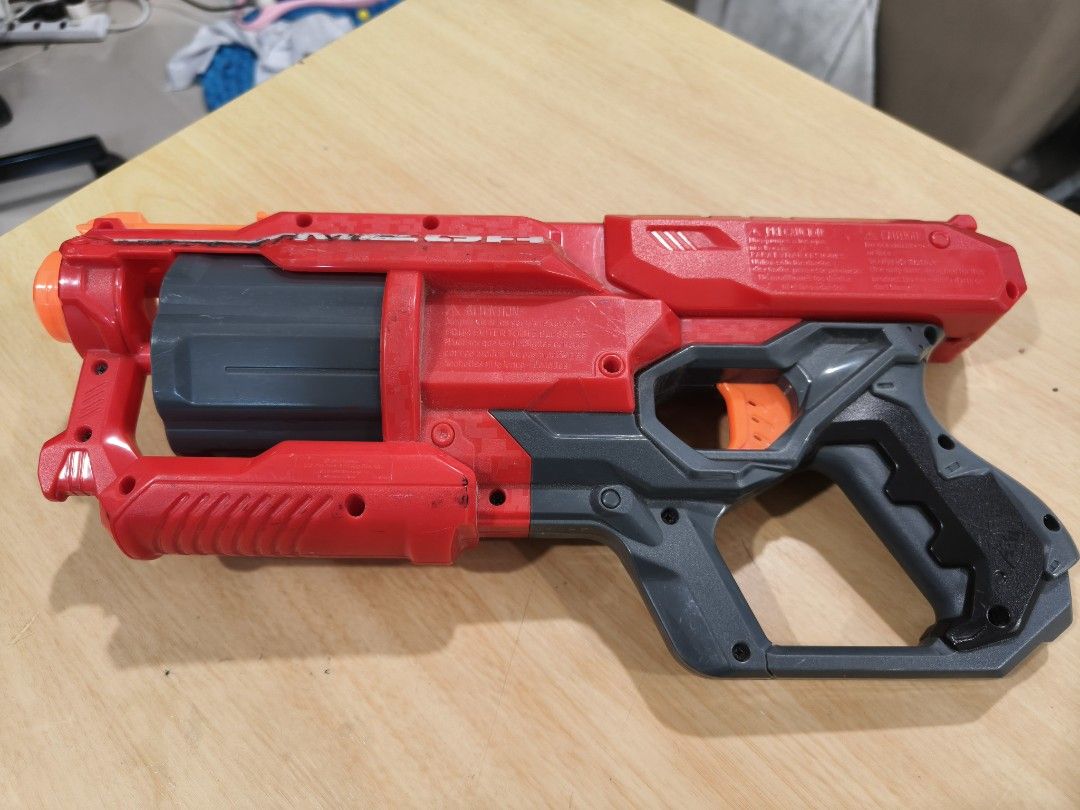 Nerf N-Strike Mega CycloneShock Blaster (Category: Toys & Games) located in Puchong. Submitted by gttrading (Listing ID 1451247857, Image 2). Description: - Red and grey Nerf Mega CycloneShock blaster - Fires Mega Whistler darts - Features a rotating barrel - Perfect for outdoor fun - Shows minor scuffs from normal play, but still works perfectly!.