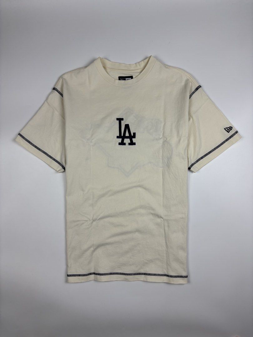 New Era La Dodgers MLB World Series Oversized Tee (Category: Activewear) located in Quezon City. Submitted by 1106_collective (Listing ID 1451264005, Image 2). Description: Size: Meduim Condition: 9.5/10 Material: 100% Cotton Made in: China Flaw / Defect: None Dimension Width: 19.5” Length: 26.5” Shoulder: 18” Sleeve: 8” .