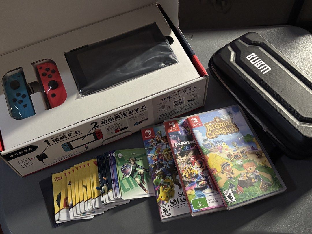 Nintendo Switch v2 Bundle (Category: Nintendo) located in Mandaluyong City. Submitted by sij__ (Listing ID 1451235168, Image 2). Description: - Nintendo Switch Console - Includes: Animal Crossing, Mario Kart 8 Deluxe, Super Smash Bros. Ultimate, Super Mario Odyssey (Mario Odyssey no case) - Comes with BUBM carrying case - All original packaging and accessories included. - BONUS: Legend of Zelda Amiibo Cards included..