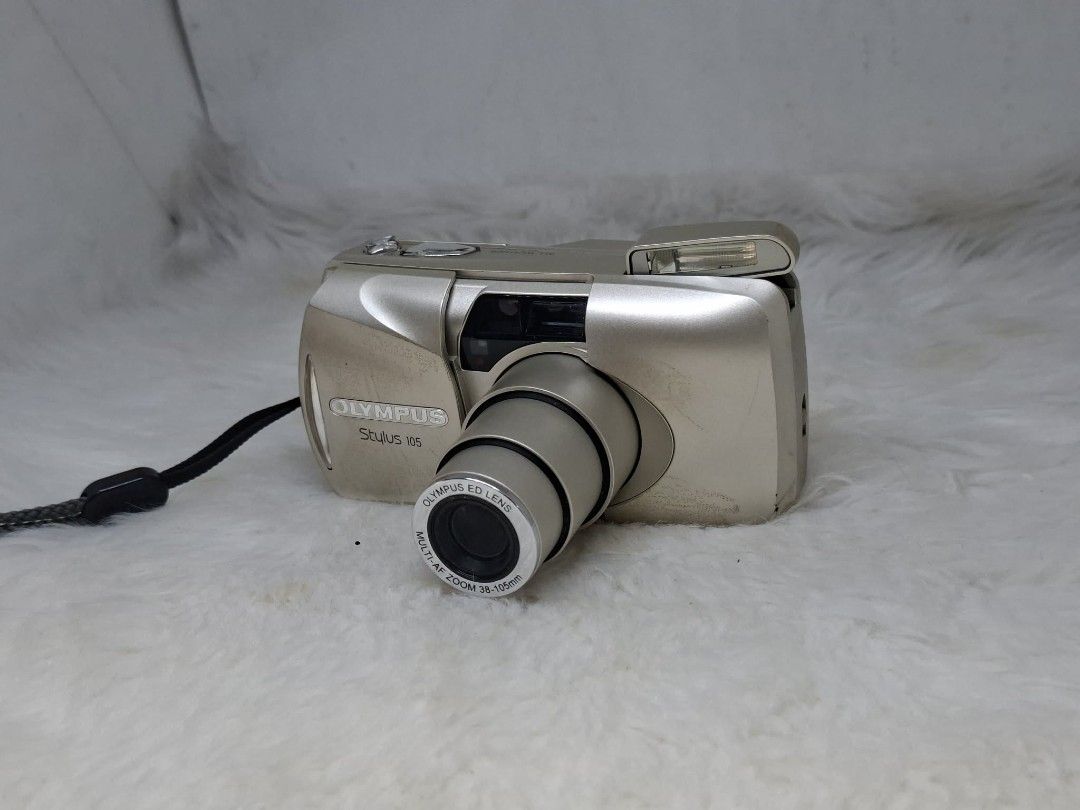 olympus stylus 105 (Category: Cameras) located in Manila. Submitted by ultimogizmos (Listing ID 1451217532, Image 3). Description: The Olympus Stylus 105 (also known as the mju: Zoom 105) is a compact, fully automatic 35mm point-and-shoot film camera . It features a weather-resistant body, a 38-105mm zoom lens, autofocus, and built-in flash modes, making it a popular, pocketable choice for everyday film photography execellent working condition wo
