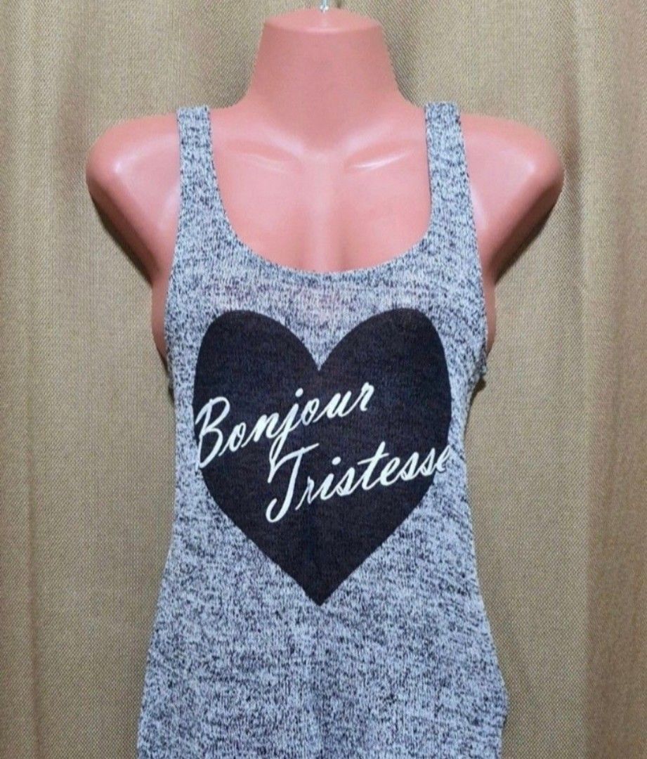 Original H&M Dividend sleeveless / tops (Category: Sleeveless) located in Manila. Submitted by phoebecali (Listing ID 1451272708, Image 1). Description: - Brand : H & M Dividend - Grey marled knit tank top - Large black heart graphic with "Bonjour Tristesse" in white script - Scoop neckline - Racerback style - Lightweight and breathable fabric - Perfect for casual wear or layering - Size : US Small - Condition : used only 1x time. Good as new Tag