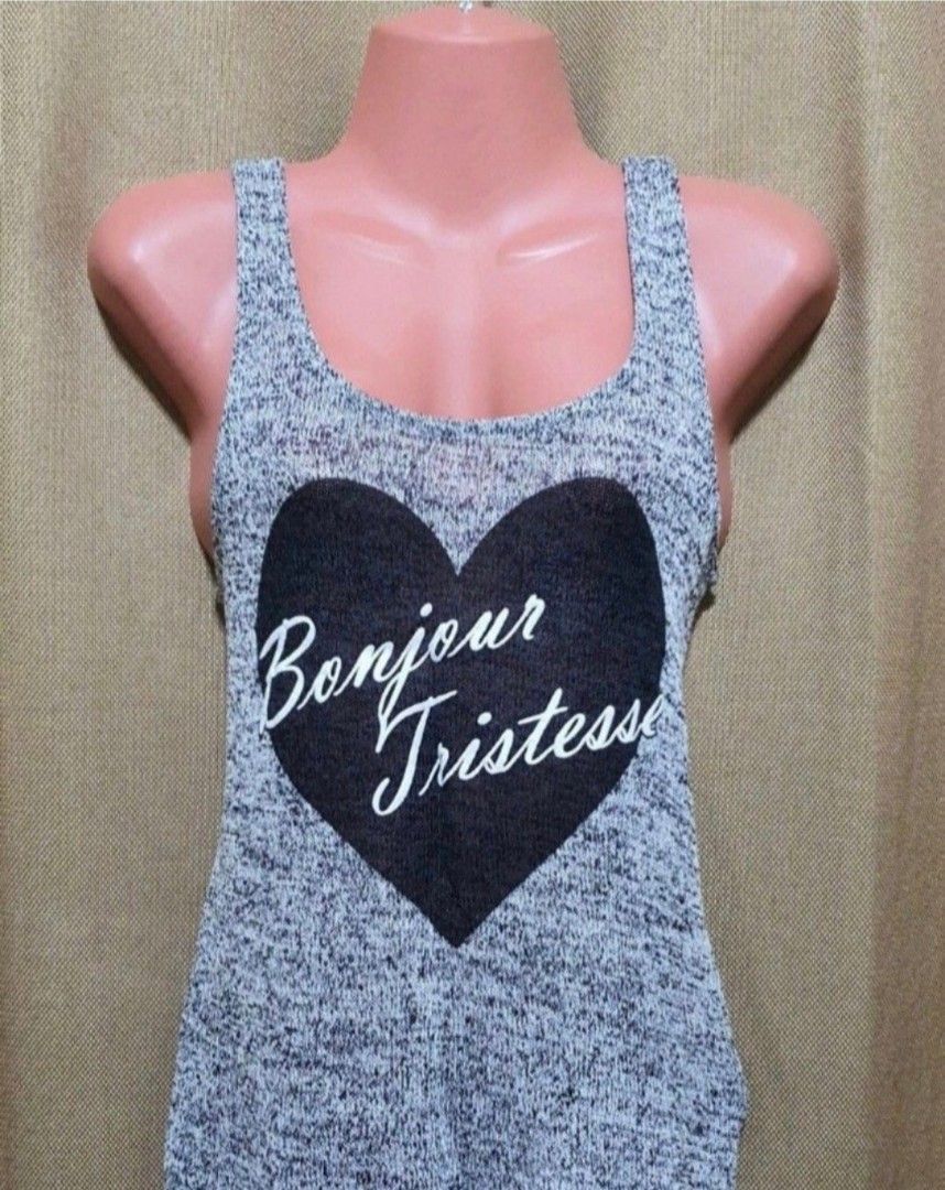 Original H&M Dividend sleeveless / tops (Category: Sleeveless) located in Manila. Submitted by phoebecali (Listing ID 1451272708, Image 2). Description: - Brand : H & M Dividend - Grey marled knit tank top - Large black heart graphic with "Bonjour Tristesse" in white script - Scoop neckline - Racerback style - Lightweight and breathable fabric - Perfect for casual wear or layering - Size : US Small - Condition : used only 1x time. Good as new Tag