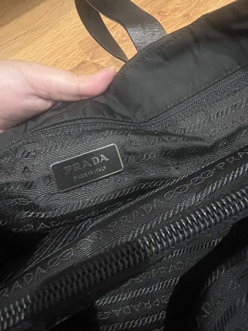 Prada Tessuto Nylon Tote Bag Black (Category: Luxury Bags & Wallets) located in Quezon City. Submitted by lovedbygrace (Listing ID 1451278699, Image 2). Description: - Authentic Prada tote bag - Durable black nylon material - Comfortable leather handles - Interior zip pocket for secure storage - Signature Prada logo lining - Includes authenticity card - Comes with original dust bag - Ideal everyday bag for your essentials.