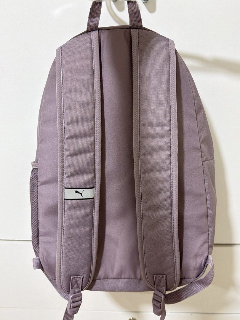 Purple Puma Backpack with Silver Logo (Category: Backpacks) located in Manila. Submitted by alt.declutter (Listing ID 1451226211, Image 2). Description: - Classic Puma backpack with iconic silver logo on the front. - Spacious zippered main compartment for all your essentials. - Convenient front pocket for quick access items. - Side mesh pockets, perfect for water bottles or umbrellas. - Adjustable shoulder straps ensure a comfortable fit for ever