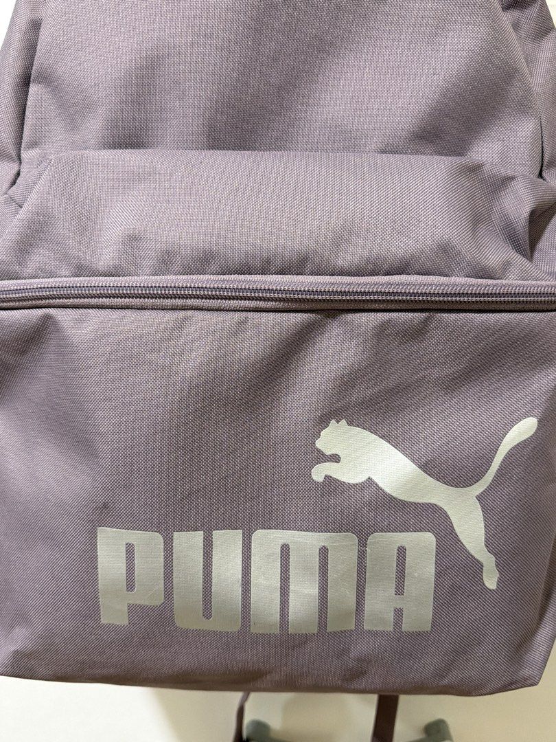 Purple Puma Backpack with Silver Logo (Category: Backpacks) located in Manila. Submitted by alt.declutter (Listing ID 1451226211, Image 3). Description: - Classic Puma backpack with iconic silver logo on the front. - Spacious zippered main compartment for all your essentials. - Convenient front pocket for quick access items. - Side mesh pockets, perfect for water bottles or umbrellas. - Adjustable shoulder straps ensure a comfortable fit for ever