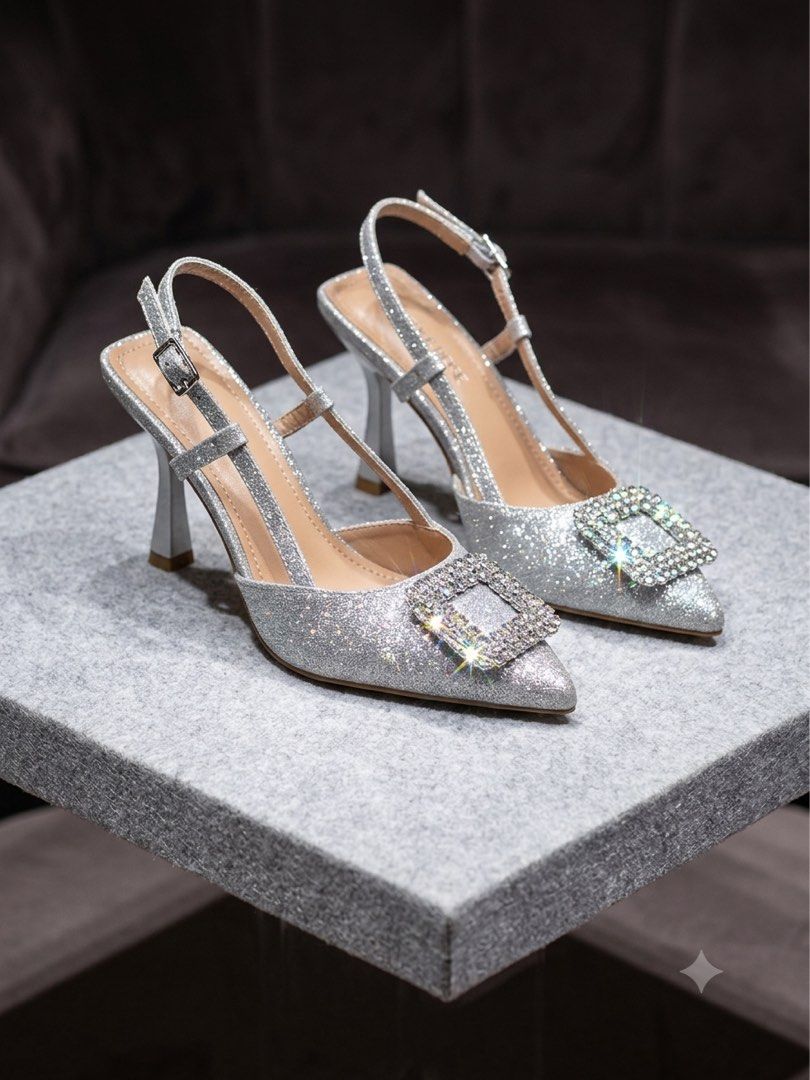 Sparkly Silver Slingback Heels with Rhinestone Buckle (Category: Heels) located in Muntinlupa City. Submitted by brandsdeclutter (Listing ID 1451228457, Image 1). Description: - Stunning silver glitter slingback heels - Elegant pointed toe design - Delicate ankle strap with buckle closure - Large square rhinestone buckle accent on the front - Comfortable and stylish flared block heel - Ideal for parties, events, or a night out.