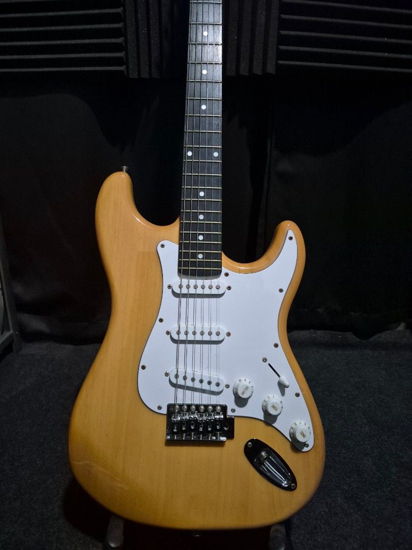Stratocaster (ST1 Series) - Natural Finish (Category: Musical Instruments) located in Antipolo. Submitted by psycho_ocean (Listing ID 1451299594, Image 2). Description: Specification: *Body: Solid ash wood *Neck: Maple *Fingerboard: Rosewood *Frets: 22 *Pickups: S-S-S (Single-coil) *Controls: 1 volume, 2 tones, and 3-way/ 5-way switch *Bridge: 2-pivot tremolo bridge *Scale length: 25½"(648mm) *Hardware: Die-cast machine heads The following are in