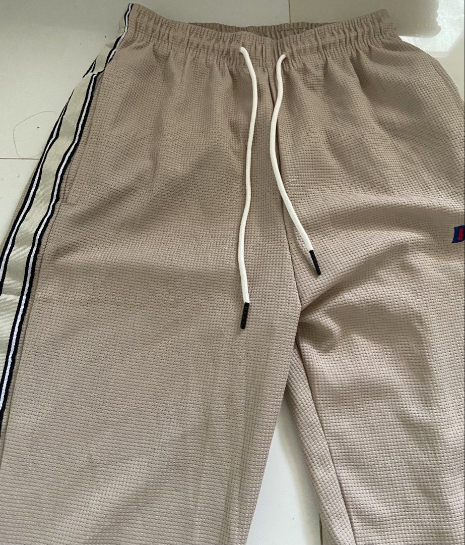⭐️Tan Track Pants with Side Stripe (Category: Other Bottoms) located in Bangui. Submitted by loricam (Listing ID 1451246097, Image 3). Description: - Tan colored track pants - Waffle knit texture for comfort - White drawstring at the waist - Side stripe detail (white, black, blue) - Small embroidered logo on left thigh - Perfect for casual wear Free Shipping for 1k plus worth of orders .