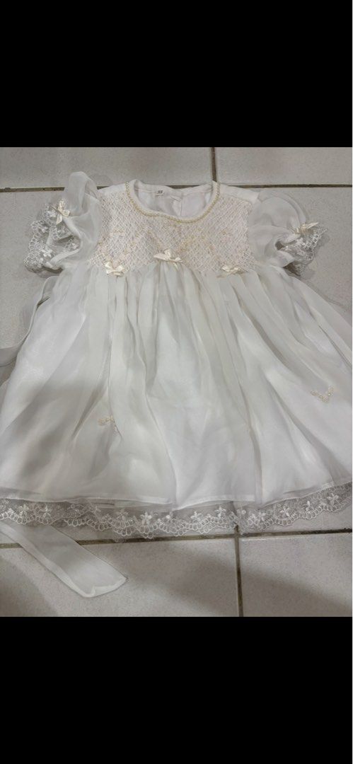 White Christening Gown Baby Girl Lace Pearls (Category: Babies & Kids Fashion) located in Puchong. Submitted by raralara (Listing ID 1451155226, Image 2). Description: - Beautiful white baby dress - Delicate lace and pearl details on bodice and sleeves - Sheer skirt overlay with lace trim - Includes matching sash - Perfect for special occasions like christenings or weddings.
