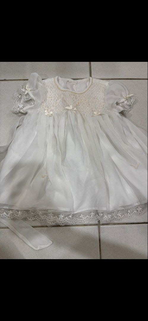 White Christening Gown Baby Girl Lace Pearls (Category: Babies & Kids Fashion) located in Puchong. Submitted by raralara (Listing ID 1451155226, Image 1). Description: - Beautiful white baby dress - Delicate lace and pearl details on bodice and sleeves - Sheer skirt overlay with lace trim - Includes matching sash - Perfect for special occasions like christenings or weddings.