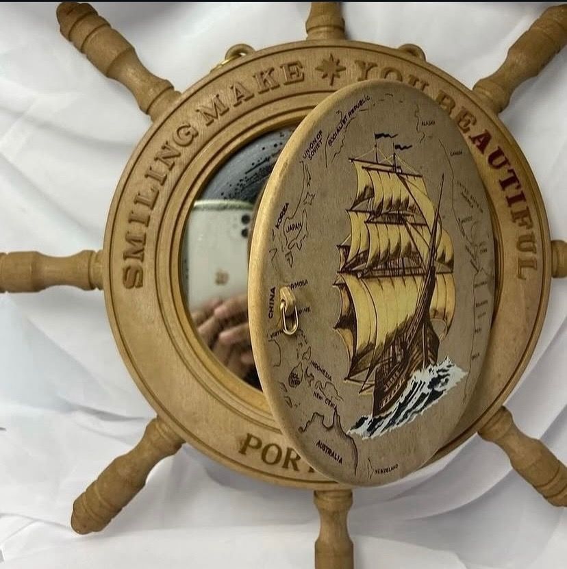 Wooden Ship Wheel Wall Decor with Mirror and Compartment (Category: Mirrors) located in Taguig. Submitted by Rare_findsmnl (Listing ID 1451136439, Image 2). Description: 💴SALE ₱499 Port of Kobe Hanging mirror ₱550 L:15” D:9.2” round base Mirror size 6.5” Last post for tonight 🤩 - Unique wooden ship wheel wall decor - Features a sailing ship design - Includes text: 'SMILING MAKE YOU BEAUTIFUL PORT OF KOBE' - Opens to reveal a mirror - Hidden com