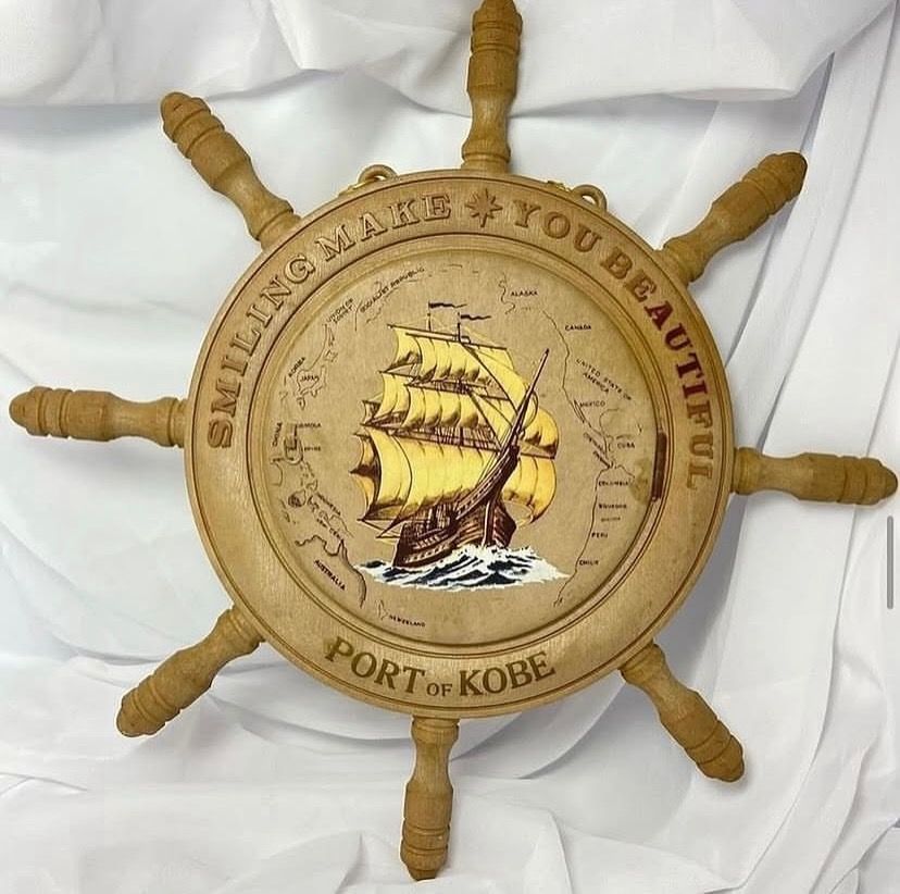 Wooden Ship Wheel Wall Decor with Mirror and Compartment (Category: Mirrors) located in Taguig. Submitted by Rare_findsmnl (Listing ID 1451136439, Image 1). Description: 💴SALE ₱499 Port of Kobe Hanging mirror ₱550 L:15” D:9.2” round base Mirror size 6.5” Last post for tonight 🤩 - Unique wooden ship wheel wall decor - Features a sailing ship design - Includes text: 'SMILING MAKE YOU BEAUTIFUL PORT OF KOBE' - Opens to reveal a mirror - Hidden com