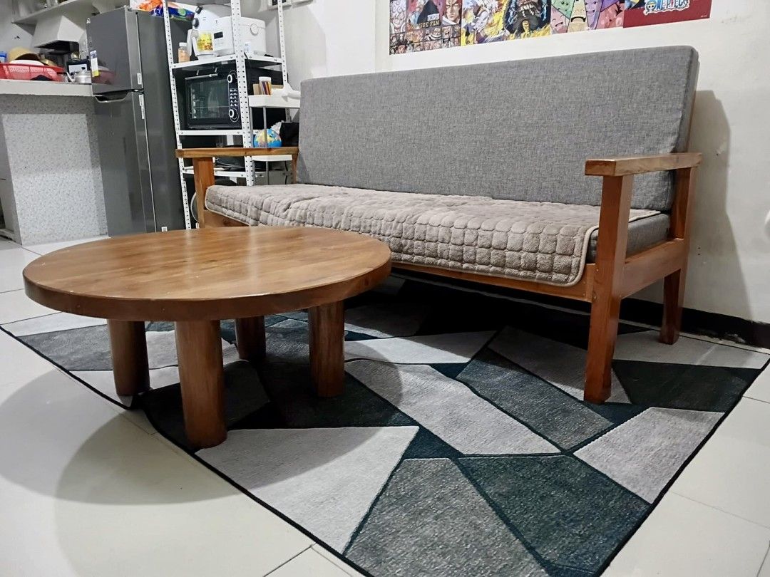 Wooden Sofa with Grey Cushions (Category: Sofas) located in Quezon City. Submitted by delacruzara (Listing ID 1451306227, Image 3). Description: - Comfortable wooden sofa with plush grey cushions. - Includes a matching round wooden coffee table. - Natural wood finish adds a warm, inviting look. - Removable cushion covers for easy cleaning. - Ideal for living rooms or small spaces. - Perfect for relaxing or hosting guests. - Pick up only..