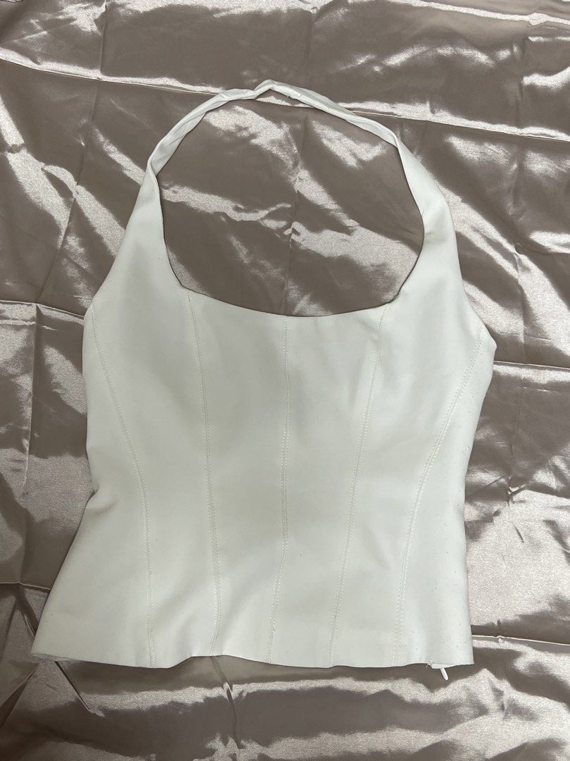 Zara White Halter Top (Category: Sleeveless) located in Quezon City. Submitted by declutterwithrei (Listing ID 1451288464, Image 1). Description: Zara white halter neck corset top, size XS. Versatile for summer, parties, or casual wear. Best fits 32-34A bust and 23-25 waist. ❗️Also for sale in Black, same size.