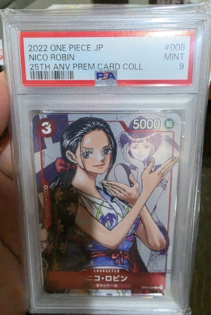 2022 One Piece JP Nico Robin PSA 9 Mint Card (Category: Graded Singles) located in Taytay. Submitted by king_ayamiku (Listing ID 1451408600, Image 1). Description: - 2022 One Piece JP Nico Robin Card - Graded PSA 9 Mint - From the 25th Anniversary Premium Card Collection - Rare find for any One Piece fan or collector.