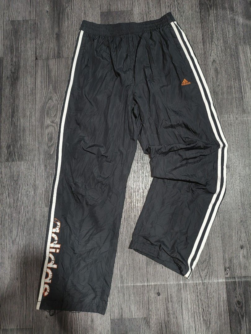 Adidas Track Pants Joggers (Category: Joggers) located in Manila. Submitted by ererane19 (Listing ID 1451440583, Image 2). Description: - Classic black Adidas track pants - Iconic white stripes down the sides - Signature orange Adidas logo on the front - Comfortable drawstring waist - Elasticated cuffs for a snug fit - Perfect for sports or casual styling.