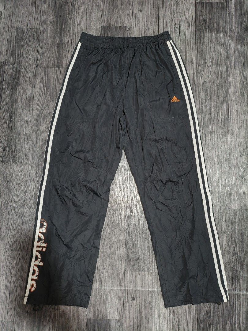 Adidas Track Pants Joggers (Category: Joggers) located in Manila. Submitted by ererane19 (Listing ID 1451440583, Image 1). Description: - Classic black Adidas track pants - Iconic white stripes down the sides - Signature orange Adidas logo on the front - Comfortable drawstring waist - Elasticated cuffs for a snug fit - Perfect for sports or casual styling.