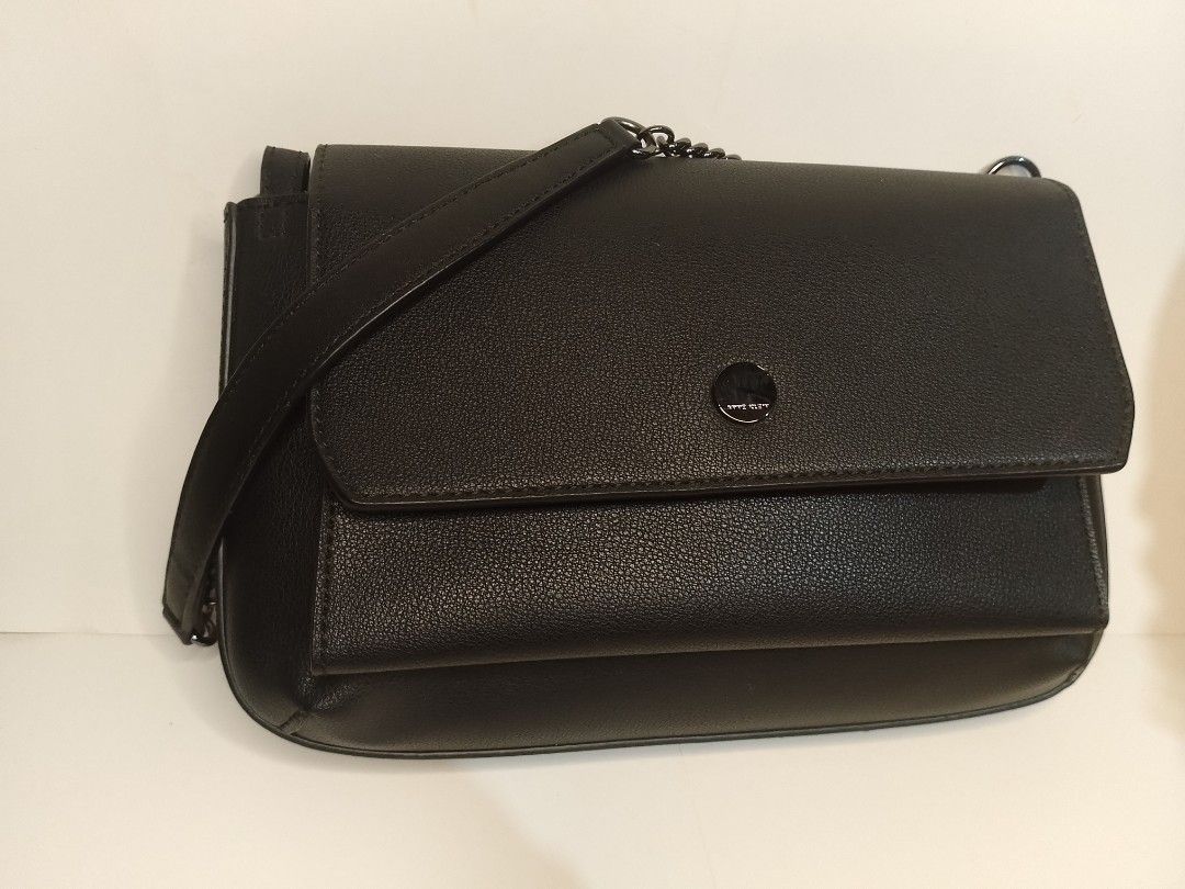 Anne Klein Structured Aesthetic Shoulder Bag (SRP: $70-$100) (Category: Shoulder Bags) located in San Miguel. Submitted by skirt_girlph (Listing ID 1451378360, Image 2). Description: Flap-style structured aesthetic black shoulder bag. Has 2 compartments with inside and back pockets. Has minimal hair lines on opening hardware. Has an unnoticeable mark on the right side of the flap but it can be cleaned (see last photo). Overall like new condition.
