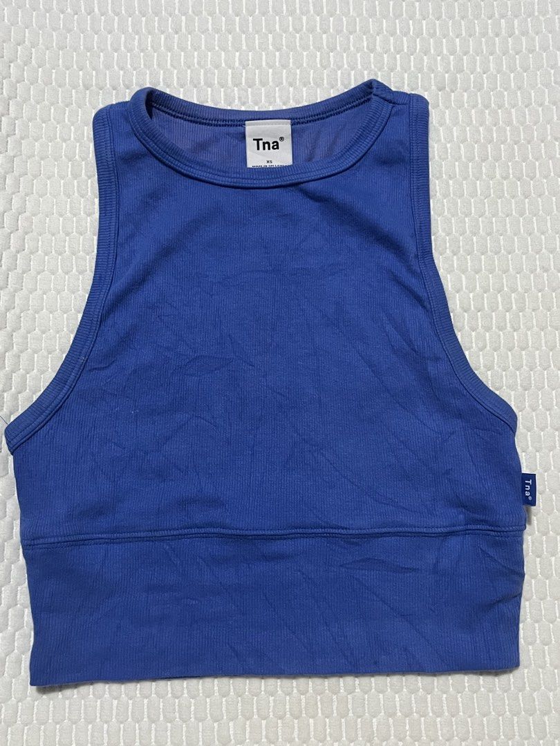 Aritzia Tna Blue Ribbed Cropped Tank Top (Category: Activewear) located in Muntinlupa City. Submitted by lovedbysabel (Listing ID 1451443546, Image 2). Description: Blue Tna Tank Top Soft ribbed fabric with a flattering cropped fit. Great for layering or wearing on its own. I only wore this once for a Pilates class. Since it fits me perfectly, I didn't need to wear a bra underneath. The fit is supportive enough to wear on its own, making it extra