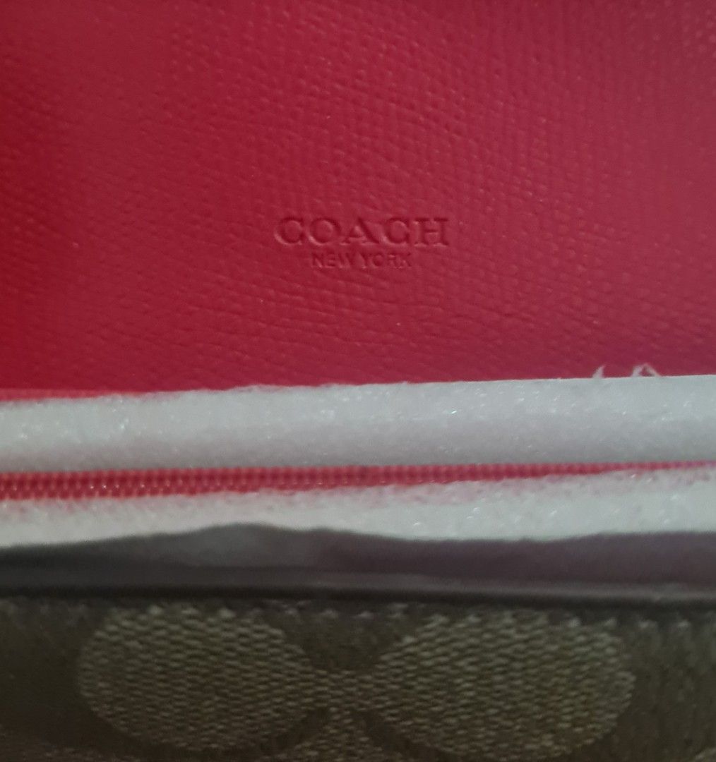 AUTHENTIC Coach Signature C Monogram Long Wallet (Category: Luxury Bags & Wallets) located in Paranaque City. Submitted by lorem45 (Listing ID 1451327105, Image 2). Description: NEVER BEEN USED! - Authentic Coach long wallet - Signature C monogram canvas exterior - Bright pink leather interior - Multiple card slots for organization - Zippered pocket for coins - Secure snap closure.