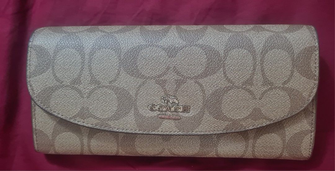 AUTHENTIC Coach Signature C Monogram Long Wallet (Category: Luxury Bags & Wallets) located in Paranaque City. Submitted by lorem45 (Listing ID 1451327105, Image 1). Description: NEVER BEEN USED! - Authentic Coach long wallet - Signature C monogram canvas exterior - Bright pink leather interior - Multiple card slots for organization - Zippered pocket for coins - Secure snap closure.