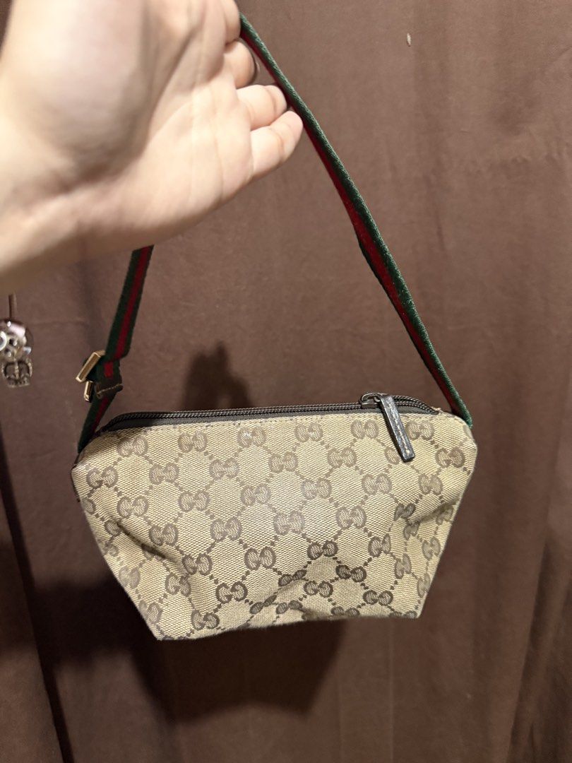 Authentic Gucci Mini Pochette Bag (Category: Luxury Bags & Wallets) located in Quezon City. Submitted by lovedbyry (Listing ID 1451429109, Image 2). Description: - Authentic Gucci pouch bag - Classic GG monogram canvas - Iconic green and red stripe strap - Zipper closure - Small size, ideal for essentials (aroun 8.5-9 inches) - Made in Italy - Please check photos for detailed condition.