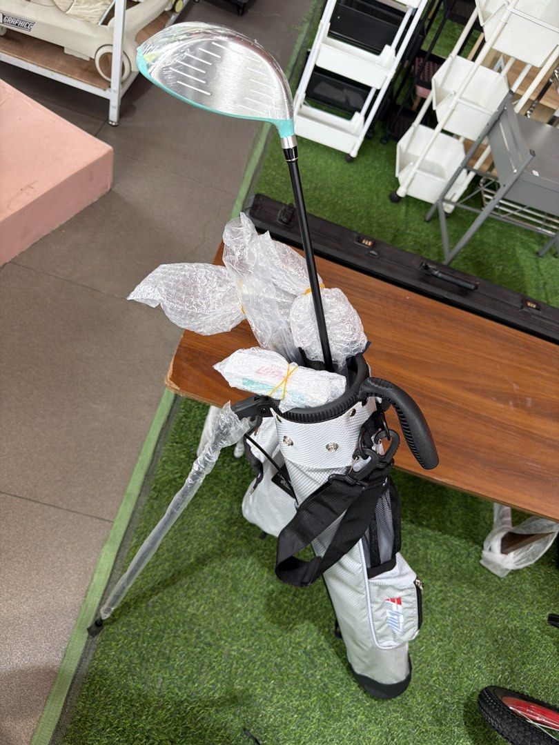 Beginner Golf Club Set - Driver, Putter, Irons (Category: Golf) located in Manila. Submitted by escubursm (Listing ID 1451375737, Image 1). Description: - Complete beginner golf set - Includes: Driver (light blue head), Putter (white with light blue accent), 2 Irons (silver heads, black shafts) - Clubs are brand new, still in protective plastic wrap - Ideal for those new to the game of golf.