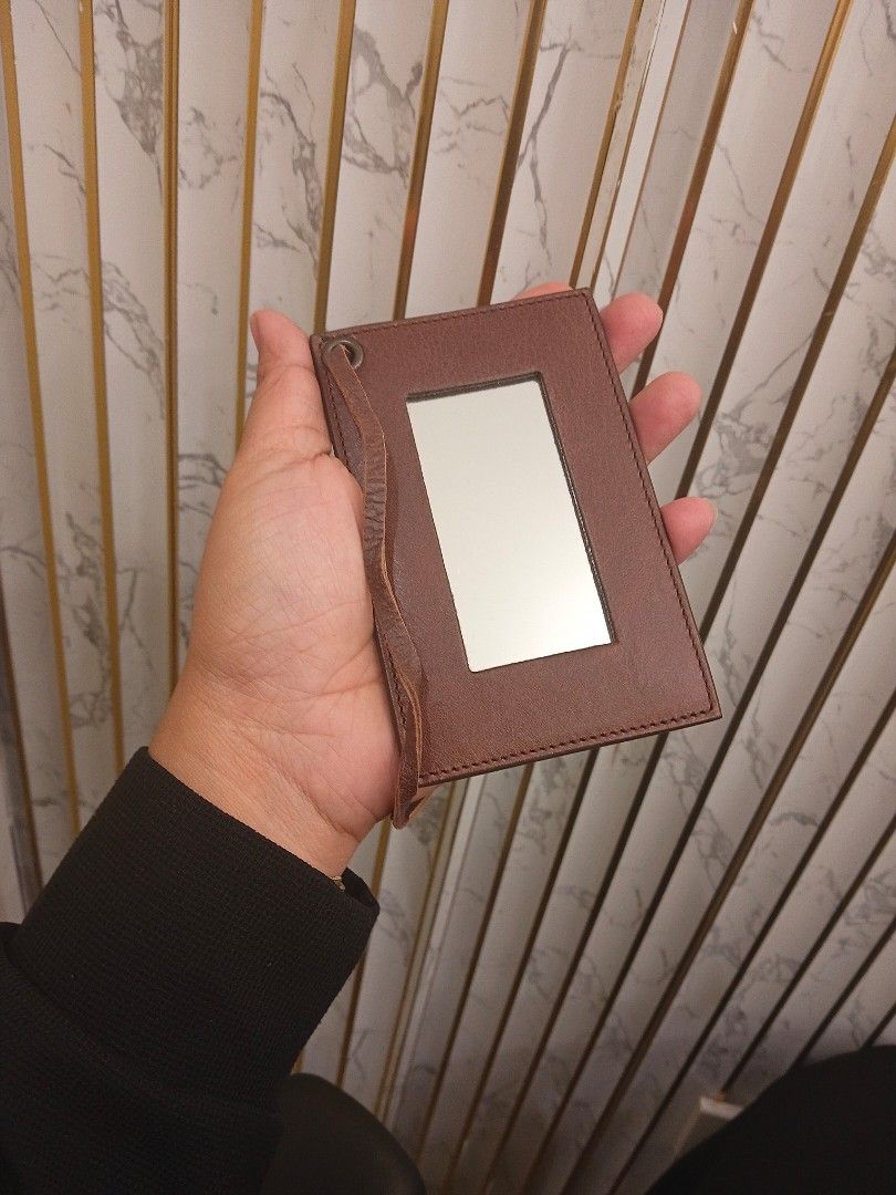 Brown Leather Compact Mirror with Strap (Category: Mirrors) located in Mandaluyong City. Submitted by rossannela00032 (Listing ID 1451420275, Image 2). Description: - Compact brown leather mirror - Attached leather strap for portability - Ideal for on-the-go touch-ups - Features a pleasant leather texture - Clear, high-quality mirror.