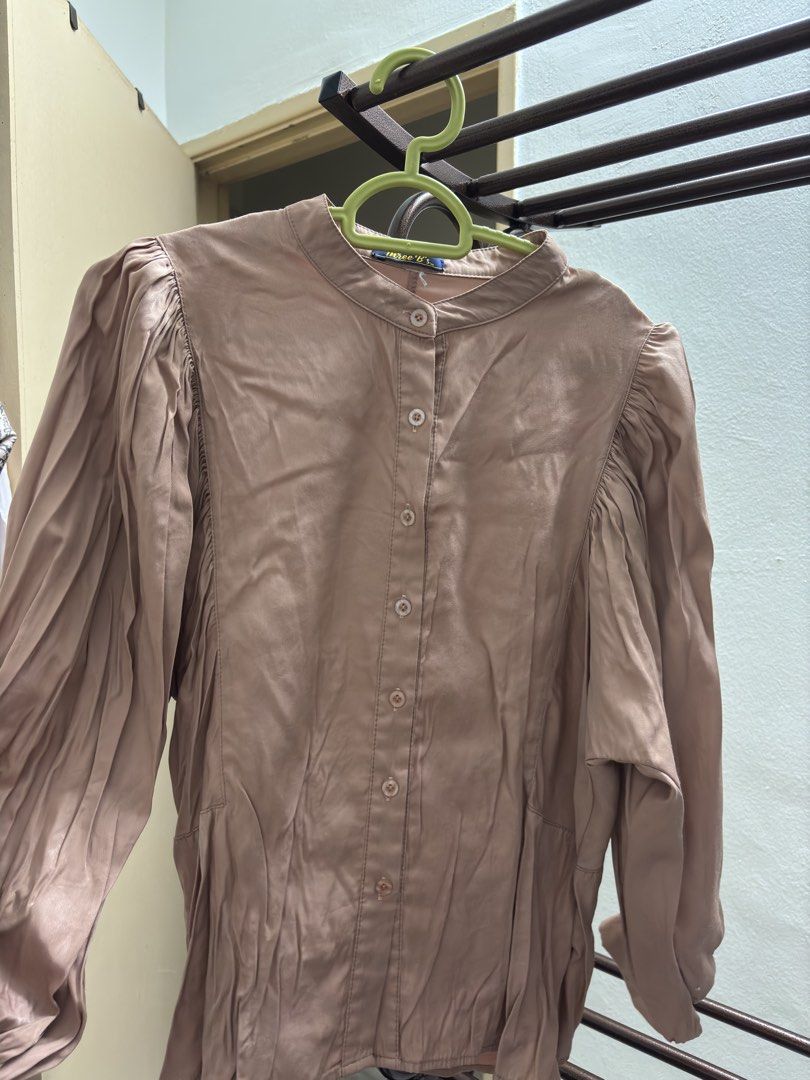 Brown Puff Sleeve Button Up Blouse (Category: Blouses) located in Kuala Lumpur. Submitted by wnyshl (Listing ID 1451446096, Image 1). Description: - Brown long sleeve blouse - Button-up front with collared neckline - Puff sleeves with gathered details - Material has a slight sheen - Perfect for dressing up or down.