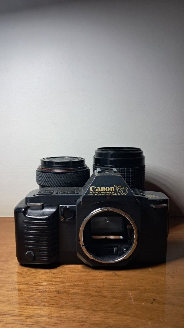 Canon T70 Computerized Film Camera (Category: Cameras) located in Manila. Submitted by cobydog (Listing ID 1451460428, Image 2). Description: CANON T70 1. The set includes the camera body (in great condition with minimal signs of usage) and two lenses (well-used with some issues). 2. The set is packed in the original package with the lenses. 3. The camera requires two (2) AAA alkaline batteries. BREAKDOWN OF PRICE: 1. Canon T70 Body: PHP 4,000.00