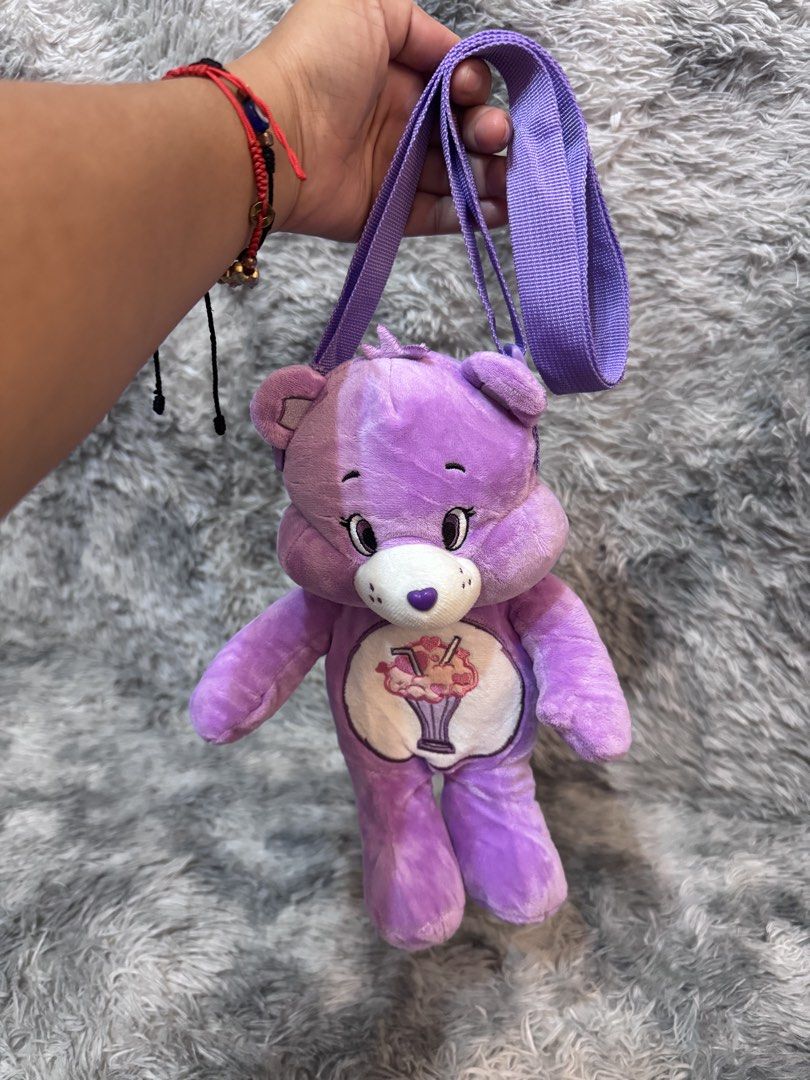 Carebears Plush Sling Bag (Category: Plushies & Soft Toys) located in Antipolo. Submitted by bhabiegraciefashionlab (Listing ID 1451353396, Image 2). Description: Purple Care bears Plush Slibg bags Small compartment Perfect for Carebears fans and collectors From japan 2 pcs avail on hand .