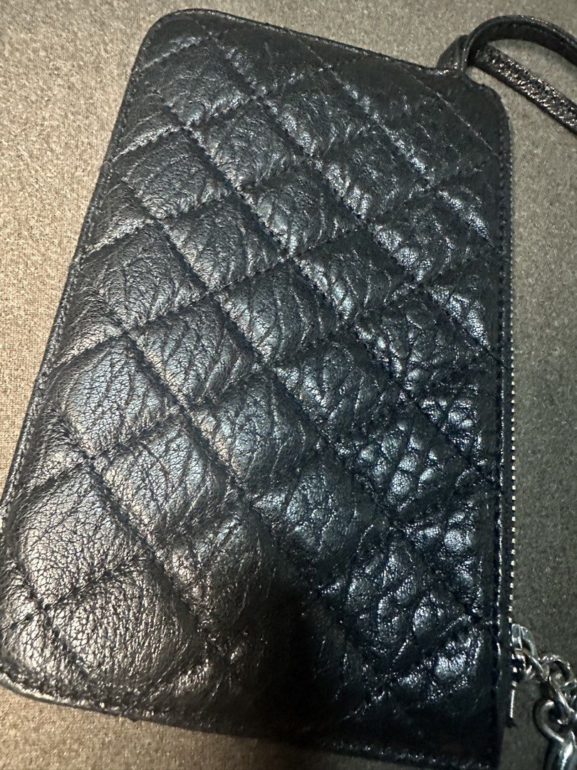 Chanel Black Quilted Leather Wristlet Pouch (Category: Luxury Bags & Wallets) located in Batangas. Submitted by jim2621 (Listing ID 1451414080, Image 3). Description: - Black quilted leather pouch - Silver CC logo charm - Detachable wrist strap - Secure zipper closure - Spacious enough for cards, cash, and small essentials - Versatile for everyday use or travel - No LOGO or Hologram inside.