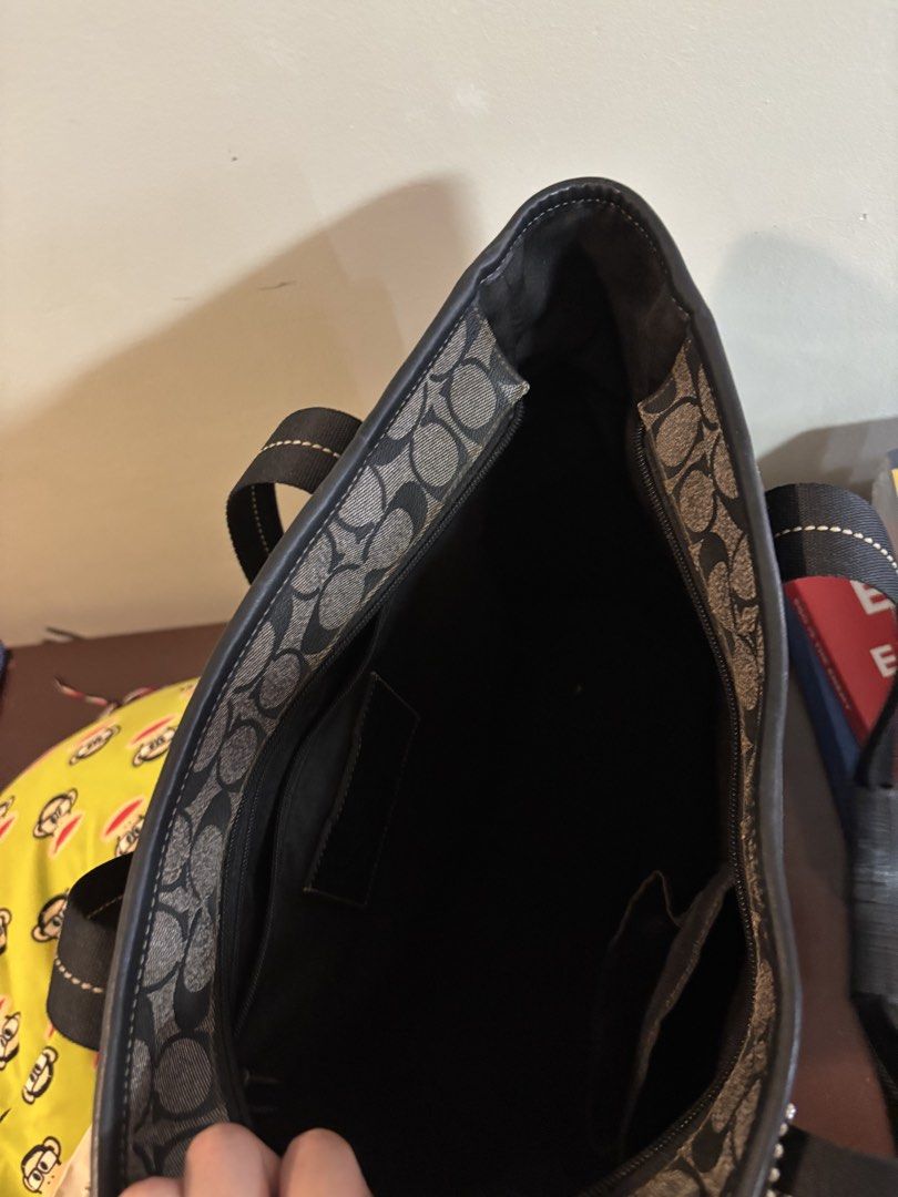 Coach Signature Monogram Tote Bag (Category: Luxury Bags & Wallets) located in Quezon City. Submitted by alphaseller88 (Listing ID 1451398857, Image 3). Description: - Classic Coach tote bag - Signature grey and black monogram pattern - Convenient side pockets for extra storage - Spacious interior with a zippered compartment - Durable black leather handles - Ideal for everyday use - bought for 15,000 php .
