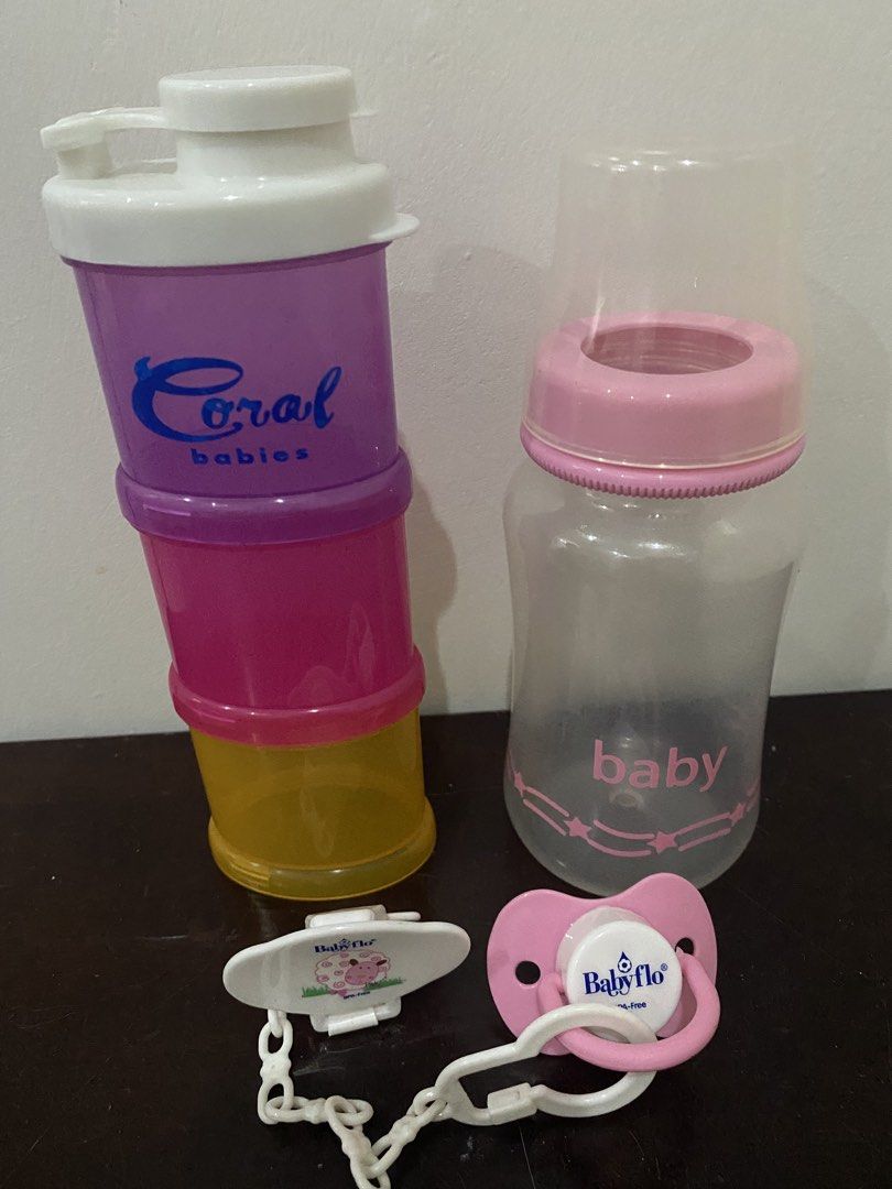 Coral Babies Stacker, Baby Bottle, Pacifier & Clip (Category: Weaning & Toddler Feeding) located in Las Pinas. Submitted by stylishchique (Listing ID 1451453695, Image 1). Description: - Coral Babies stackable formula dispenser (purple, pink, yellow) - Pink baby bottle with clear lid - Pink Babyflo pacifier - White pacifier clip - Ideal for convenient feeding on the go.