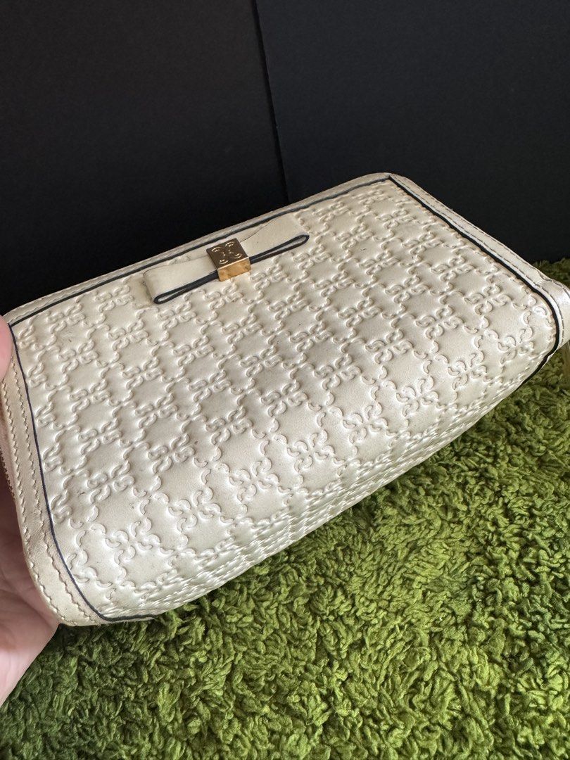 Cream Embossed Bow Zip Around Wallet (Category: Wallets & Card holders) located in Cauayan City . Submitted by espiritucj (Listing ID 1451400731, Image 2). Description: - Cream colored zip-around wallet - All-over embossed pattern - Cute bow detail on the front - Multiple card slots for organization - Zippered compartment for secure storage - Good for keeping essentials tidy - Minor signs of wear on the inside.