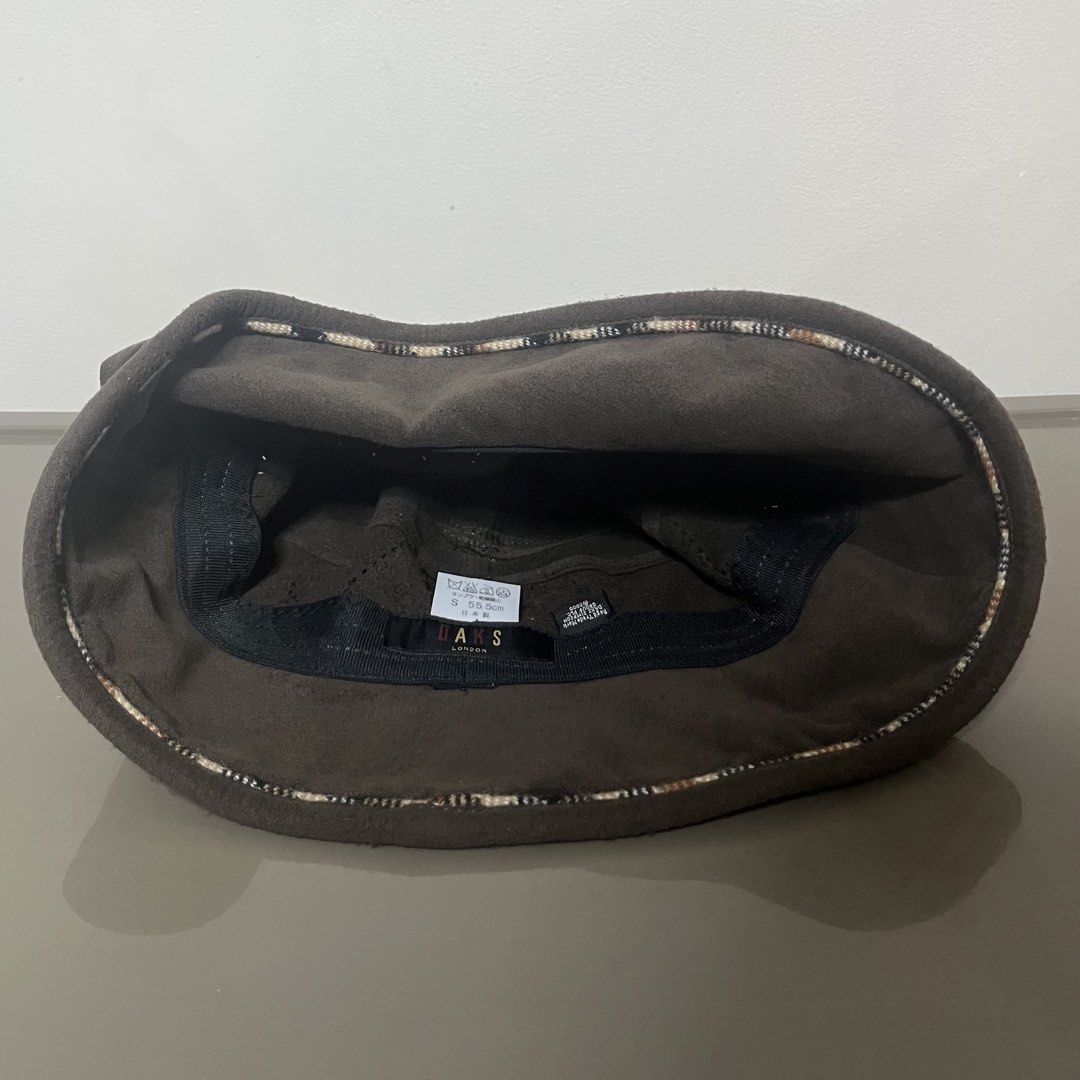 DAKS London Suede Bucket Hat (Category: Caps & Hats) located in Valenzuela. Submitted by any_thingthings (Listing ID 1451410703, Image 2). Description: - Size Small (55.5 cm) - features a decorative quilted diamond stitching and a metallic branding plate on the side.