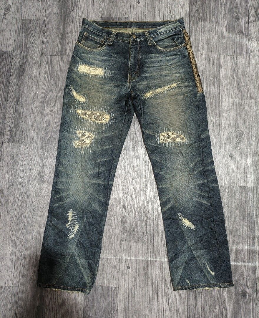 Designer Distressed Patchwork Jeans with Floral Accents (Category: Jeans) located in Manila. Submitted by ererane19 (Listing ID 1451440155, Image 1). Description: -LEVI'S JEANS -SIZE 30 - Unique patchwork and distressed denim jeans. - Features embroidered floral designs on the back pocket area. - Inner pocket lining with a repeating logo pattern. - Classic button fly closure. - Perfect statement piece to elevate your style..