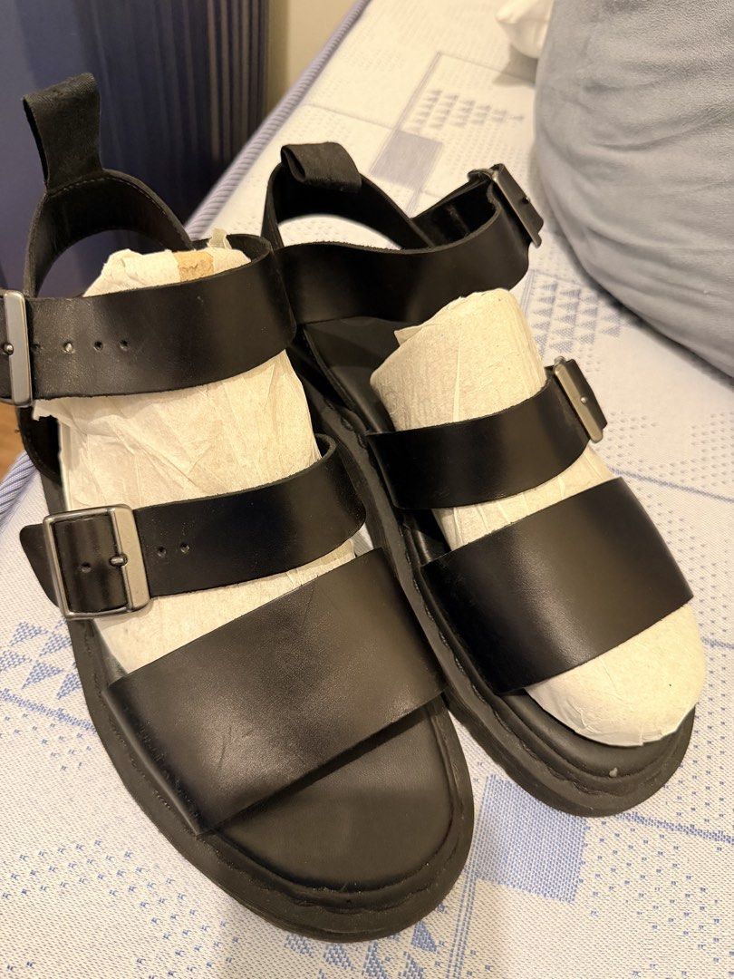 Dr. Martens Black Leather Buckle Strap Sandals (Category: Sneakers & Footwear) located in Manila. Submitted by i-sell-stuff (Listing ID 1451434290, Image 2). Description: - Genuine black leather Dr. Martens sandals - Two adjustable buckle straps across the front - Secure ankle strap with buckle closure - Iconic Dr. Martens sole with air cushioning for comfort - Perfect for everyday wear - Please check photos for detailed condition.