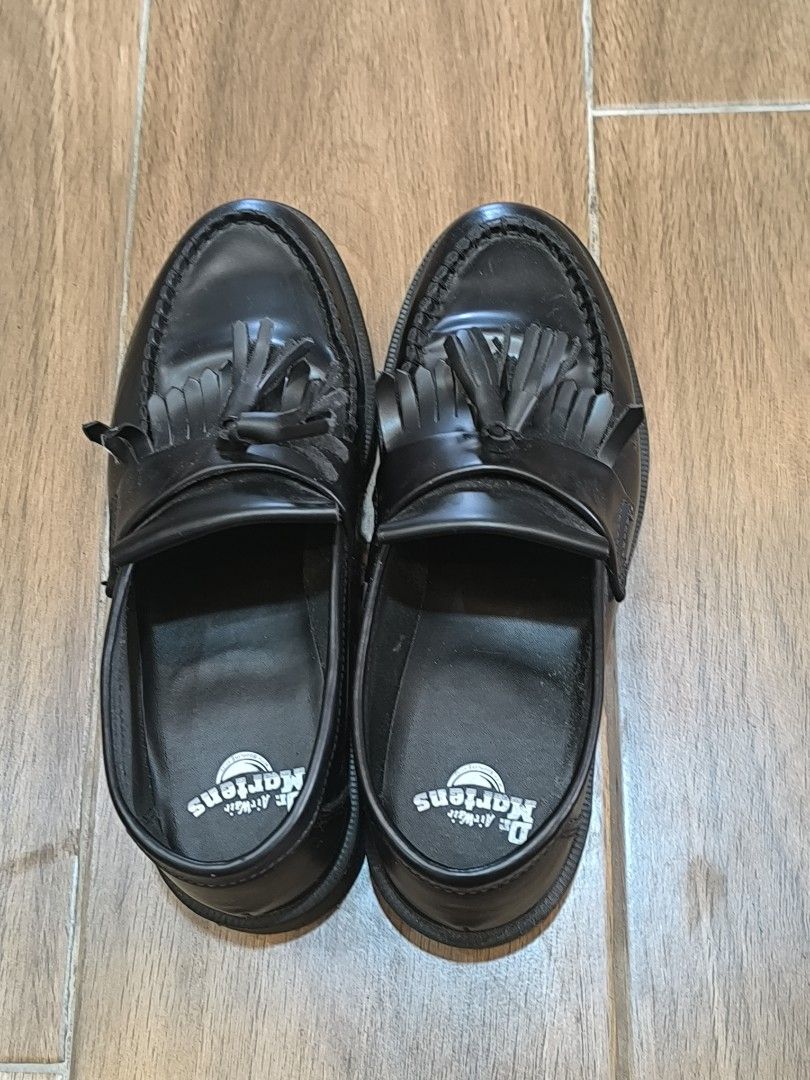 Dr. Martens Black Leather Tassel Loafers (Category: Loafers) located in Manila. Submitted by tippytottie (Listing ID 1451420524, Image 1). Description: - Classic black leather Dr. Martens loafers - Features a stylish tassel detail across the vamp - Iconic Dr. Martens air-cushioned sole for comfort and durability - Versatile for dressing up or down, perfect for everyday wear.