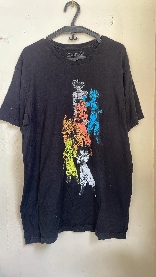 Dragon Ball Z Goku Transformations T-Shirt (Category: Tshirts & Polo Shirts ) located in Manila. Submitted by saint_thrifts (Listing ID 1451507018, Image 1). Description: - Black t-shirt featuring Goku's evolution from original to Super Saiyan Blue. - Comfortable fit for everyday wear. - Ideal for Dragon Ball Z fans, collectors, and enthusiasts. - A must-have item to showcase the legendary fighter's power-ups..
