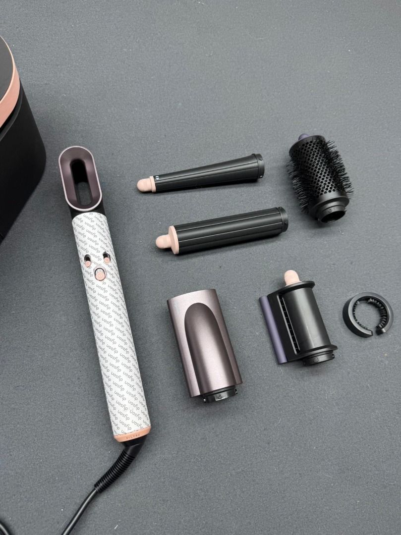 Dyson Airwrap Complete Styler Set (Category: Hair) located in Muntinlupa City. Submitted by fuzetarhub95690 (Listing ID 1451389853, Image 1). Description: - Dyson Airwrap Complete set - Includes main styler unit, various barrels, and brush attachments - All pieces fit neatly into the storage case - Comes with a black storage pouch - Ideal for achieving various hairstyles with ease.