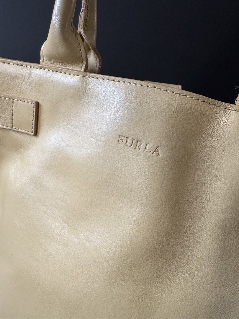 Furla Leather Tote Bag Beige (Category: Luxury Bags & Wallets) located in Cauayan City . Submitted by espiritucj (Listing ID 1451518360, Image 2). Description: - Authentic Furla tote bag in classic beige - Crafted in Italy from genuine leather - Spacious interior with branded lining - Comfortable top handles for easy carrying - Elegant buckle detail on the front - Ideal everyday bag for style and practicality.