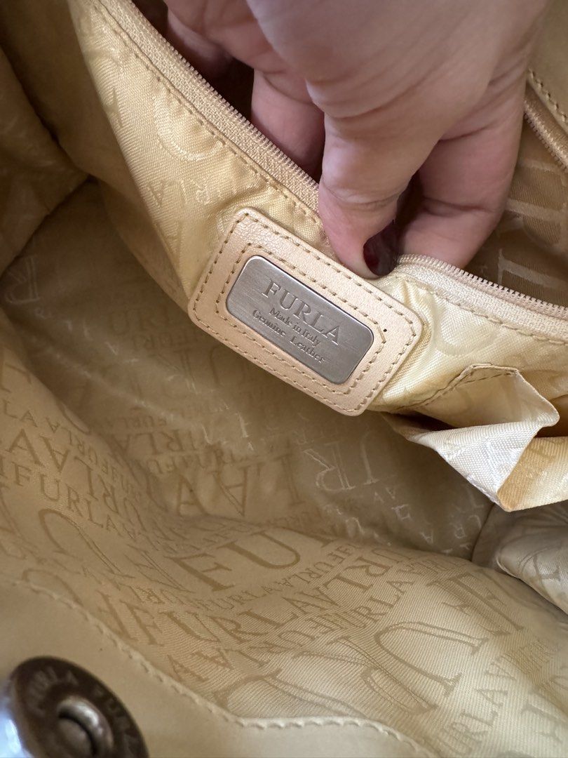 Furla Leather Tote Bag Beige (Category: Luxury Bags & Wallets) located in Cauayan City . Submitted by espiritucj (Listing ID 1451518360, Image 3). Description: - Authentic Furla tote bag in classic beige - Crafted in Italy from genuine leather - Spacious interior with branded lining - Comfortable top handles for easy carrying - Elegant buckle detail on the front - Ideal everyday bag for style and practicality.