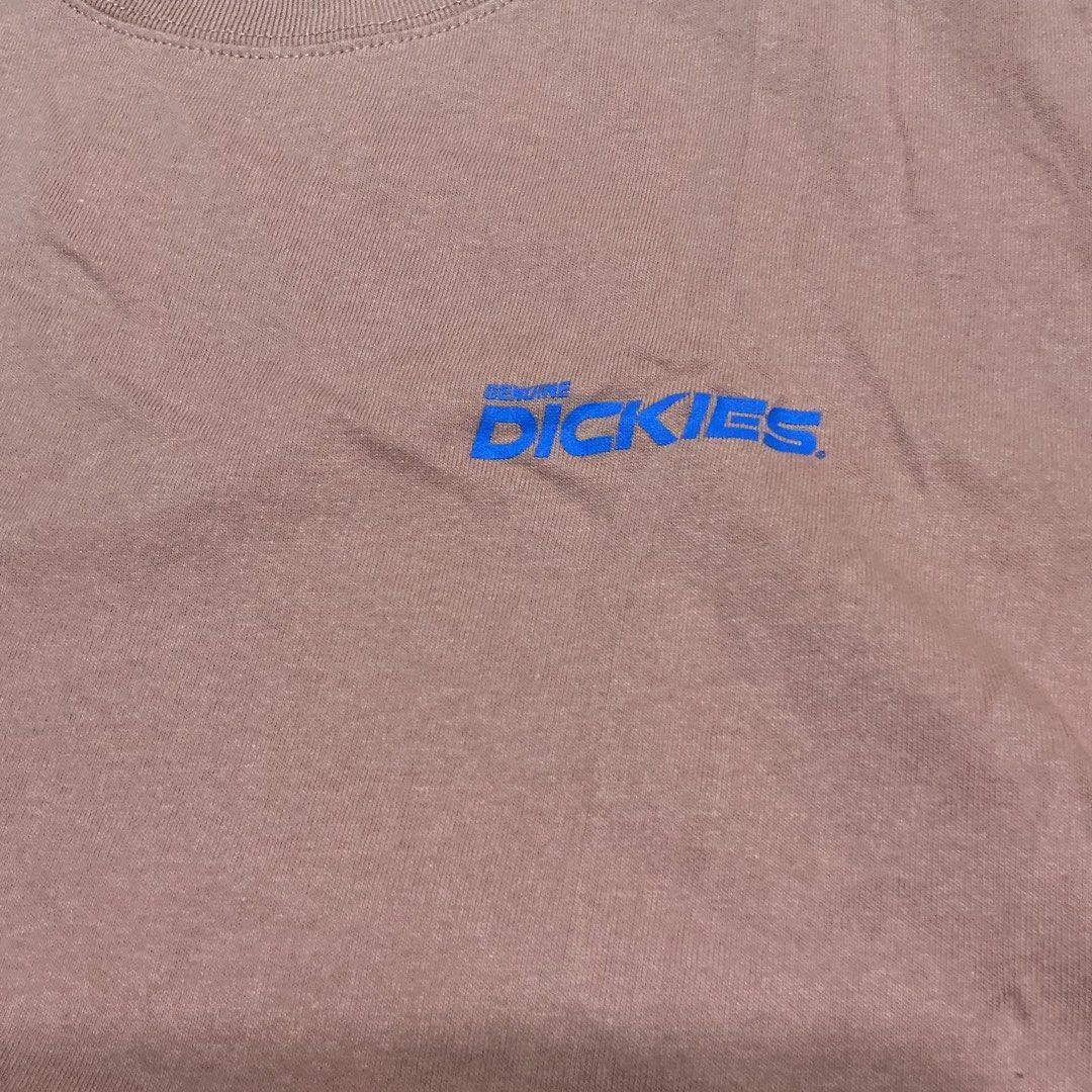 Genuine Dickies Graphic T-Shirt (Category: Tshirts & Polo Shirts ) located in Naga. Submitted by sachi_v2 (Listing ID 1451434287, Image 3). Description: - Pink Dickies graphic t-shirt - Features iconic Dickies logo - Unique graphic design with two figures on the back - Small Dickies logo tag on the sleeve - Made from comfortable cotton material - Ideal for everyday casual wear.