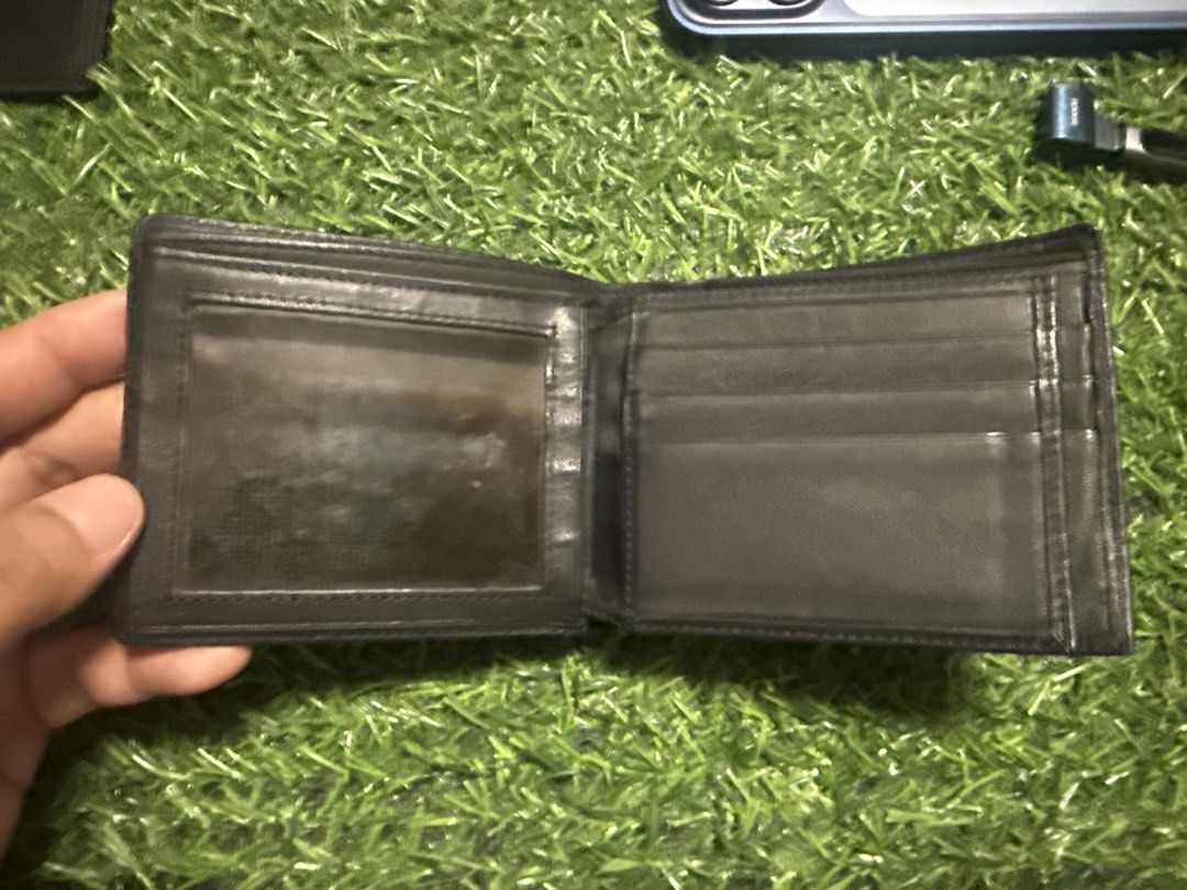 Gucci Monogram Bi-fold Wallet Black Leather (Category: Luxury Bags & Wallets) located in Marilao. Submitted by its_me_bolinoy (Listing ID 1451331550, Image 3). Description: - Genuine black leather Gucci wallet - Features iconic embossed GG monogram - Classic bi-fold design - Multiple card slots for organization - Includes a clear ID window - Stylish and practical for everyday carry.