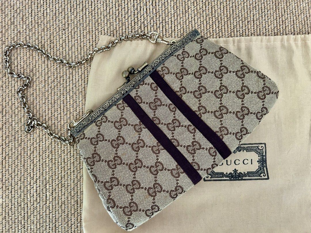 Gucci Monogram Clutch Bag with Chain (Category: Luxury Bags & Wallets) located in Legazpi City. Submitted by jjacob_018 (Listing ID 1451500016, Image 3). Description: -Negotiable- Vintage Gucci monogram clutch - Classic GG pattern - Dark brown ribbon accents - Metal chain strap - Kiss-lock closure - Interior lining with floral and script print - Authenticity not guaranteed.