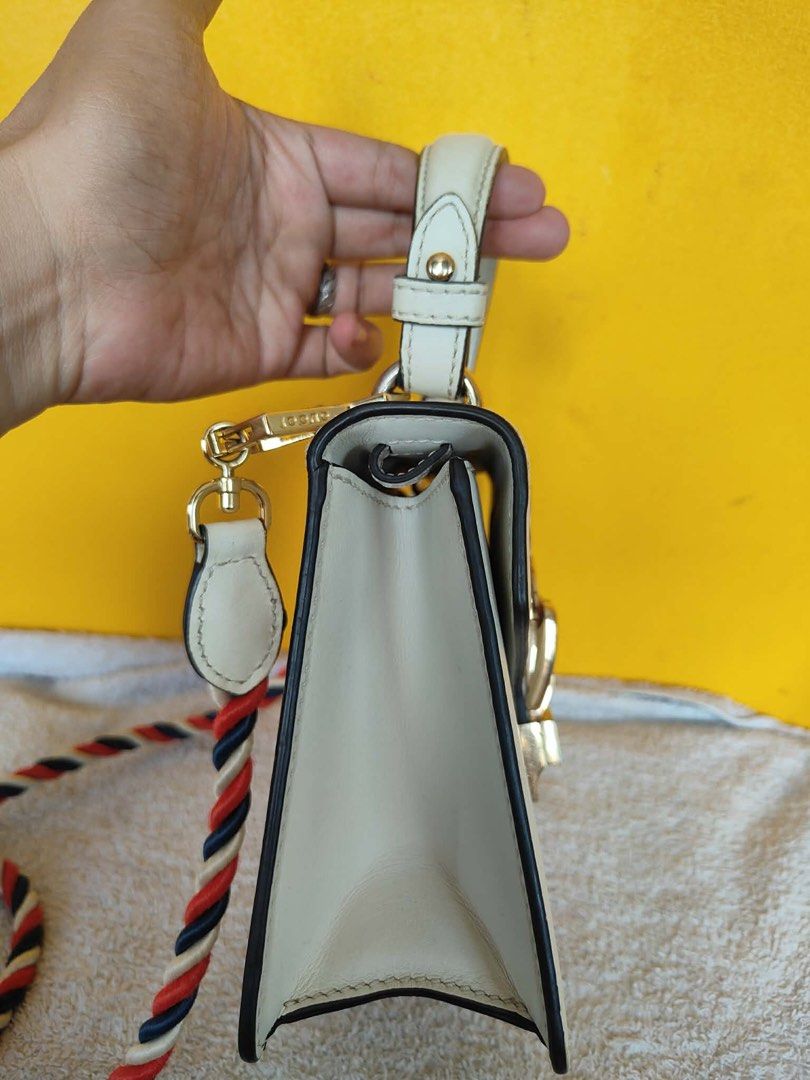 Gucci Sylvie White Leather Top Handle Bag (Category: Luxury Bags & Wallets) located in Alburquerque. Submitted by wildforest.ea4e9c (Listing ID 1446749396, Image 3). Description: - Authentic White Leather Gucci Sylvie Bag - Signature Green and Red Web Stripe - Elegant Gold Chain Detail - Detachable Braided Strap Included - Versatile: Perfect for Day or Night Use - Immaculate Interior Condition - Shiny Gold Hardware.