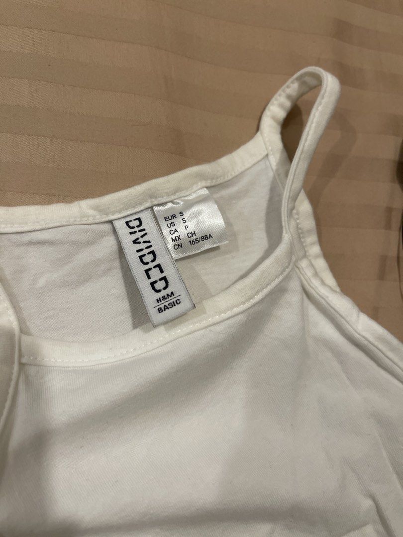 H&M Divided Basic Crop Tops (White & Black) (Category: Shirts) located in Marikina City. Submitted by bimbems (Listing ID 1451446971, Image 2). Description: - Two H&M Divided basic crop tops - White top: Size S (worn once) - Black top: Size XXS (brand new) - Material: Ribbed fabric - Design: Spaghetti straps - Versatile: Perfect for layering or wearing solo - Black top includes original tags RFS: decluttering Loc 📍: Marikina City Jnt Delivery.